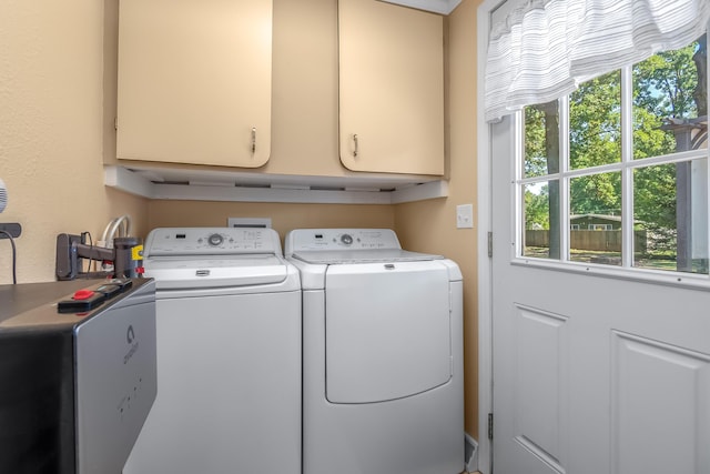 laundry room featuring cabinet space and washer and clothes dryer