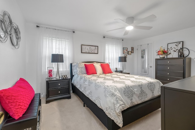 bedroom featuring light carpet and ceiling fan