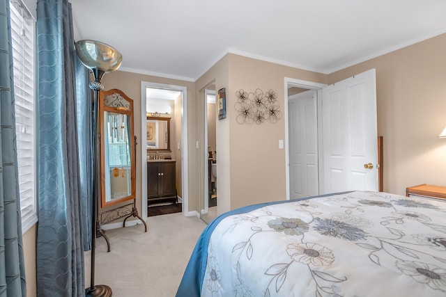 bedroom featuring baseboards, light colored carpet, crown molding, and ensuite bath