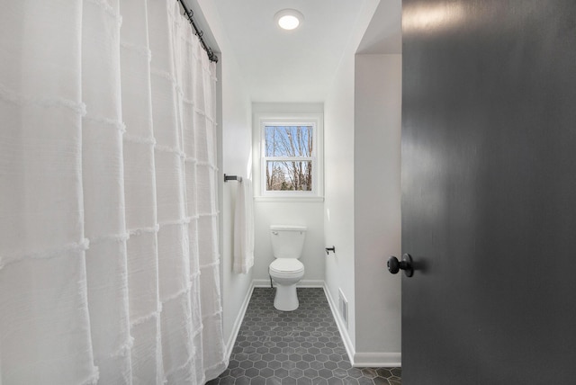 full bath with baseboards, visible vents, toilet, and tile patterned floors