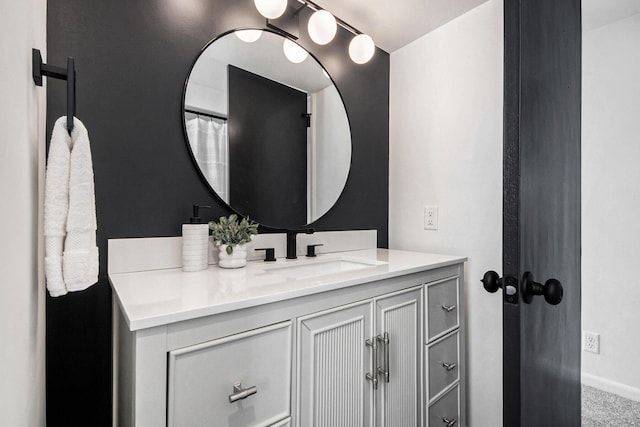 full bath featuring baseboards and vanity