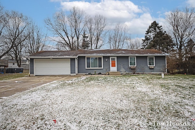 ranch-style home with concrete driveway and an attached garage