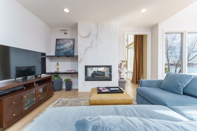 living area featuring recessed lighting and a fireplace