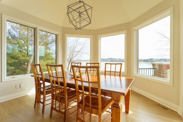 sunroom featuring vaulted ceiling, plenty of natural light, and visible vents