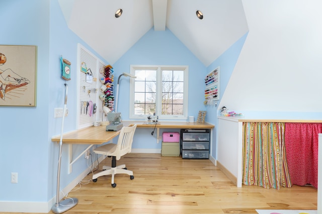 office area featuring lofted ceiling with beams, baseboards, and wood finished floors