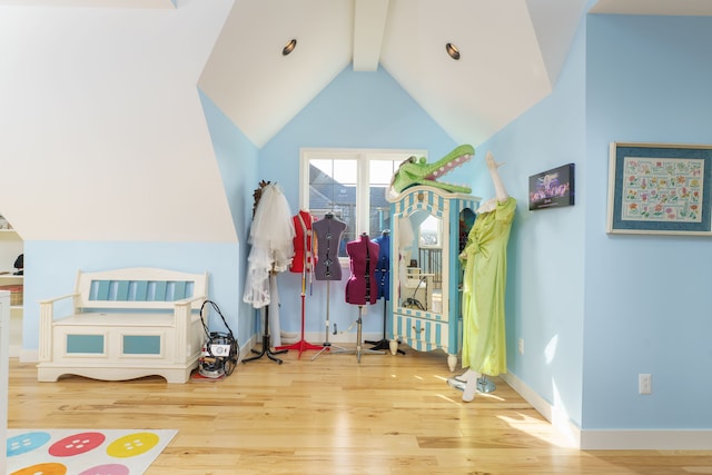 playroom featuring vaulted ceiling with beams, baseboards, and wood finished floors