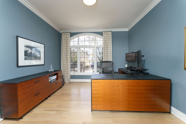 office featuring light wood-type flooring, crown molding, and baseboards