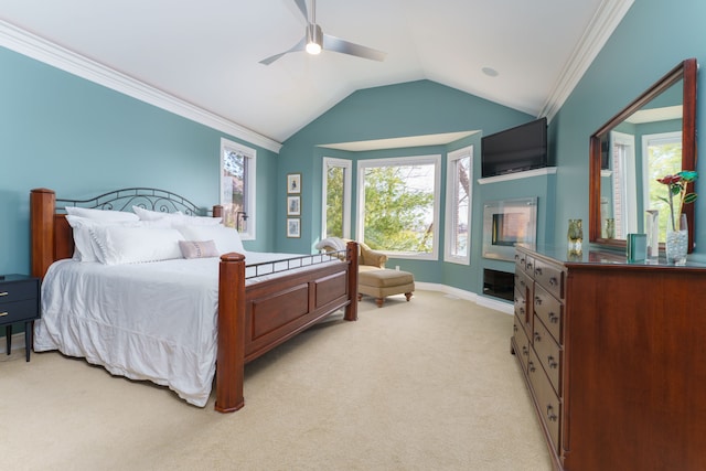 bedroom featuring baseboards, lofted ceiling, ornamental molding, light carpet, and a ceiling fan