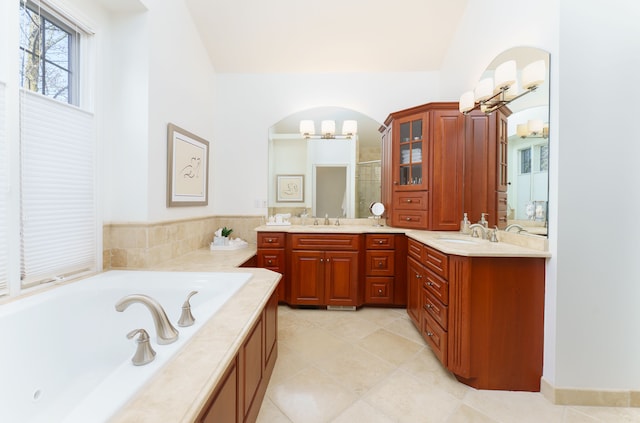 full bathroom featuring vanity, lofted ceiling, a shower stall, tile patterned floors, and a bath