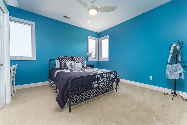 bedroom with visible vents, baseboards, and carpet