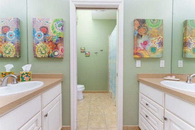 bathroom featuring tile patterned flooring, two vanities, and a sink