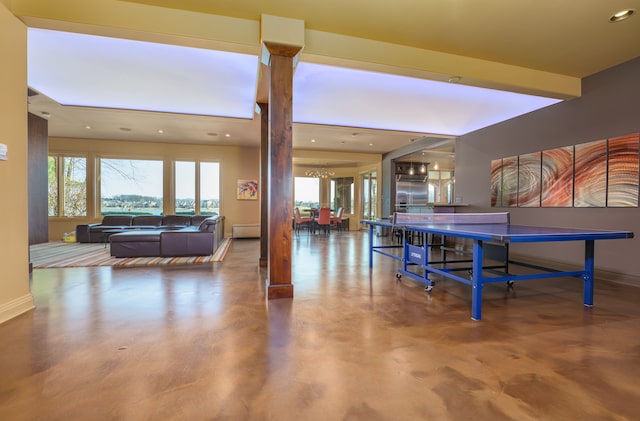 playroom with recessed lighting, baseboards, a notable chandelier, and concrete floors