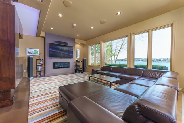 living room featuring a glass covered fireplace and recessed lighting