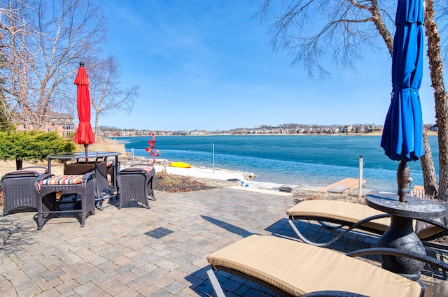 view of patio with outdoor dining space and a water view