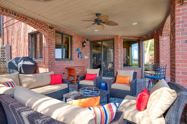 view of patio featuring an outdoor living space, area for grilling, and a ceiling fan