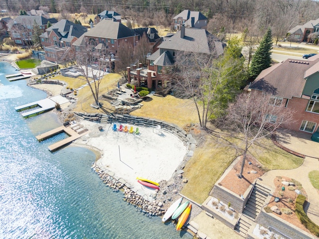 drone / aerial view with a residential view and a water view