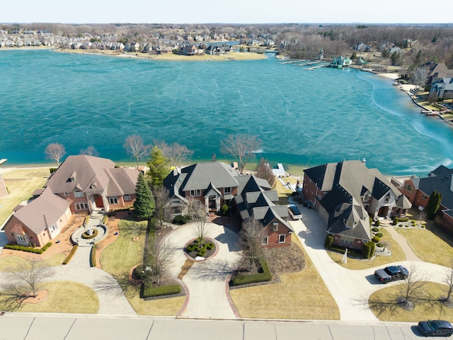 drone / aerial view featuring a residential view and a water view