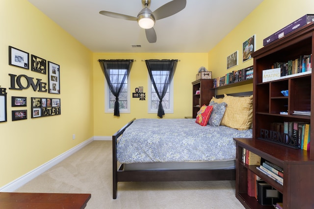 carpeted bedroom featuring baseboards, visible vents, and ceiling fan