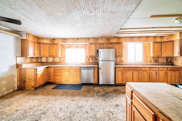 kitchen with stainless steel appliances, plenty of natural light, light countertops, and brown cabinets