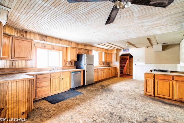 kitchen with ceiling fan, stainless steel appliances, and light countertops