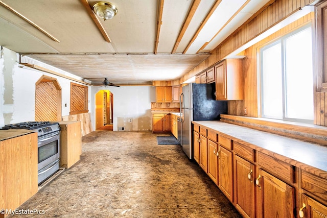 kitchen featuring ceiling fan, light countertops, appliances with stainless steel finishes, and brown cabinetry