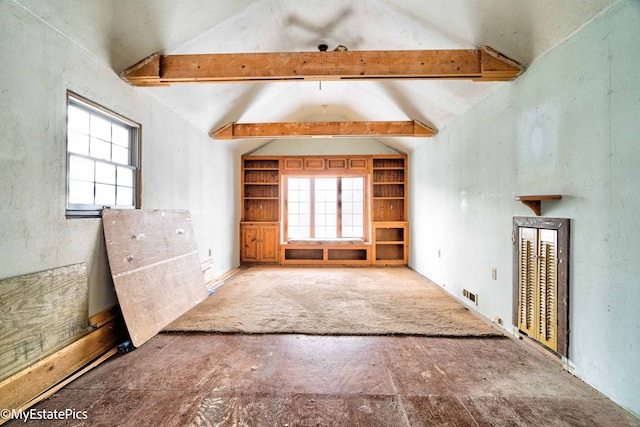 interior space with vaulted ceiling with beams, built in shelves, and a wealth of natural light