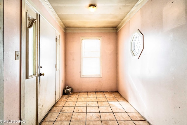 interior space with light tile patterned floors and crown molding