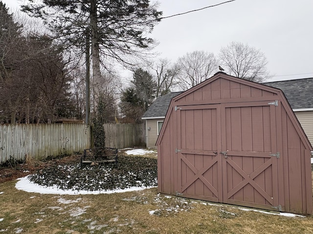 view of shed featuring fence