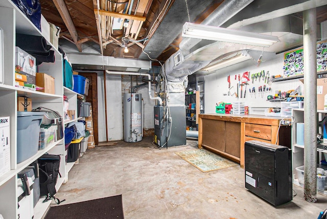 unfinished basement featuring heating unit, water heater, and a workshop area