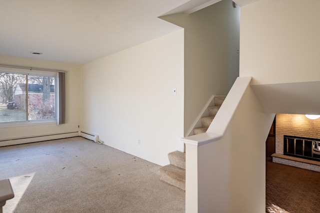 stairs featuring carpet flooring, a fireplace, and a baseboard radiator