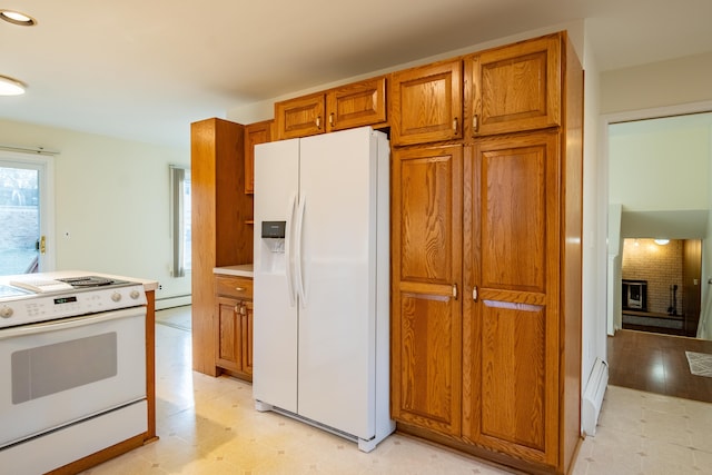 kitchen with white appliances, light floors, a fireplace, and brown cabinetry