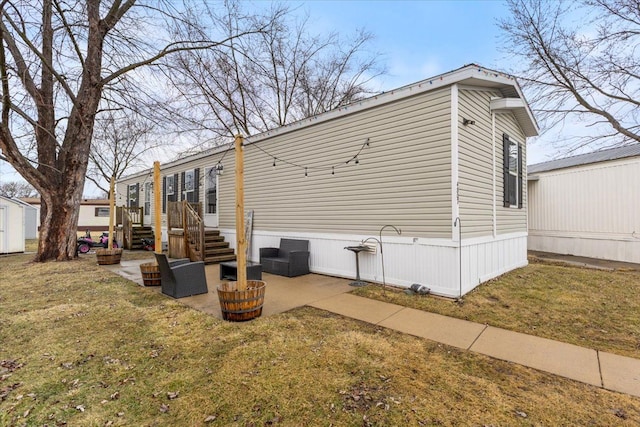 view of home's exterior featuring a patio and a lawn