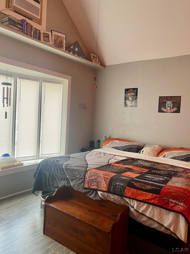 bedroom featuring vaulted ceiling and wood finished floors