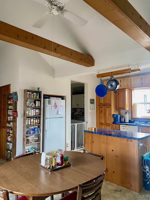 dining room with lofted ceiling with beams and a ceiling fan