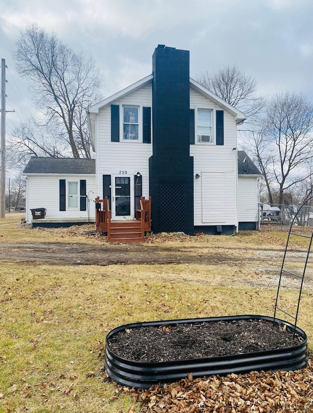 view of front of property with a chimney and a front yard