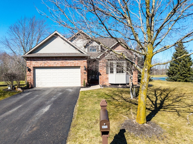 traditional-style home with brick siding, a front lawn, an attached garage, and driveway