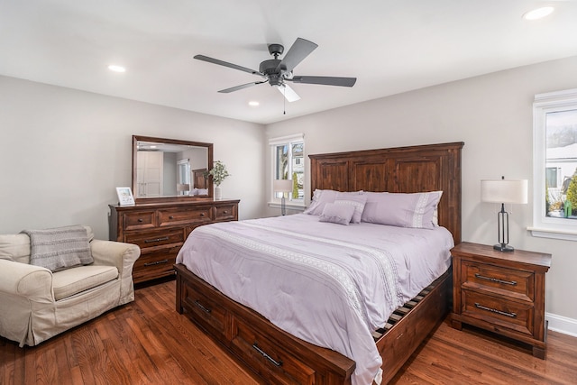 bedroom with baseboards, dark wood finished floors, a ceiling fan, and recessed lighting