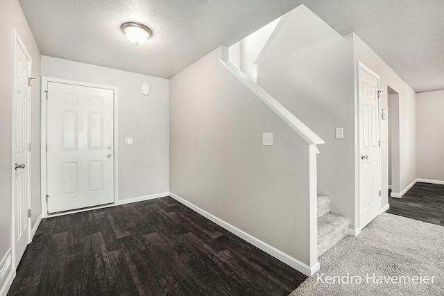 foyer featuring stairway, wood finished floors, and baseboards