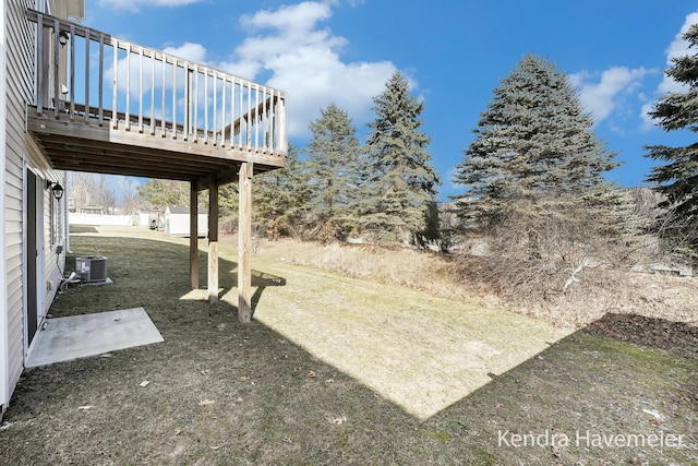 view of yard with a deck and central AC