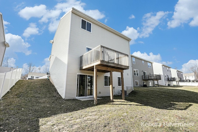 rear view of property featuring fence and a deck