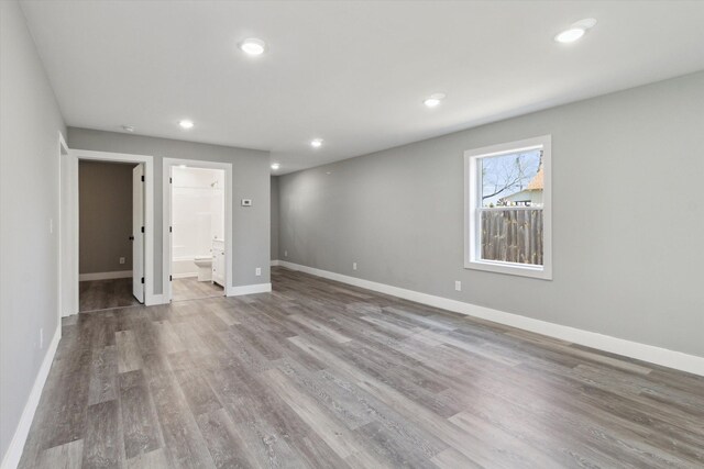 706 Colfax St, Cadillac, MI 49601 - below grade area with wood finished floors, baseboards, and recessed lighting