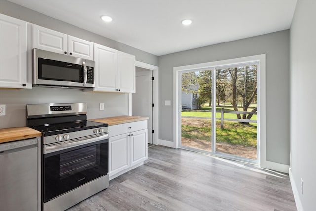 706 Colfax St, Cadillac, MI 49601 - kitchen with stainless steel appliances, wood counters, baseboards, light wood-style flooring, and recessed lighting