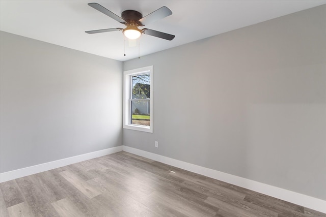 706 Colfax St, Cadillac, MI 49601 - empty room with wood finished floors, baseboards, and ceiling fan