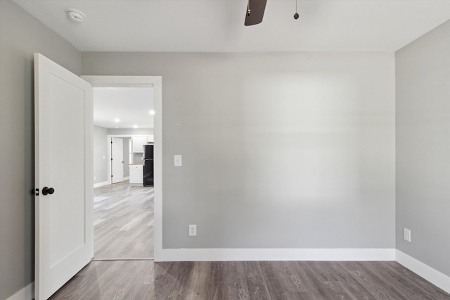 706 Colfax St, Cadillac, MI 49601 - empty room with ceiling fan, baseboards, wood finished floors, and a smoke detector