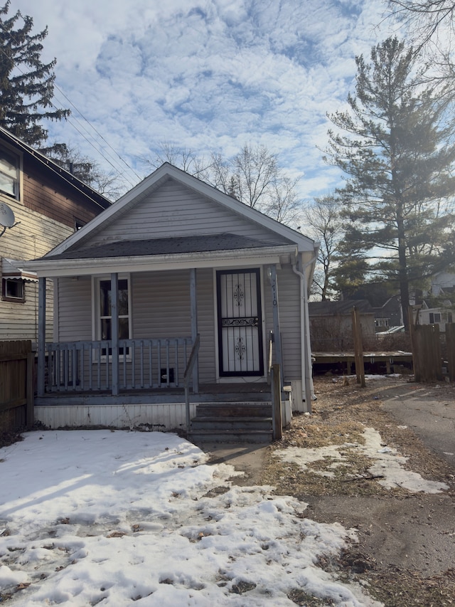 view of front of home featuring a porch and fence