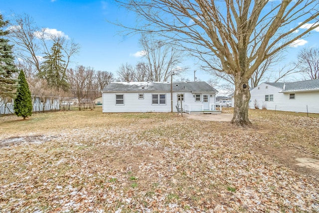 rear view of property with fence