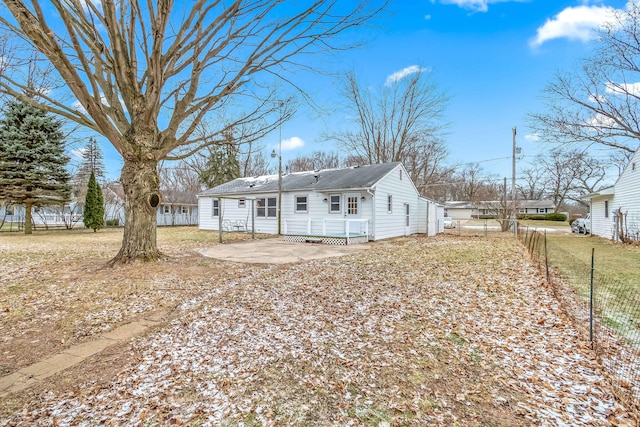 rear view of house featuring a patio area and fence