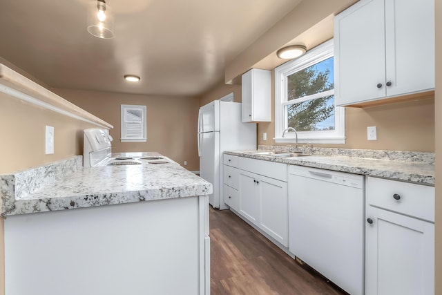 kitchen with dark wood finished floors, white appliances, white cabinetry, and a sink