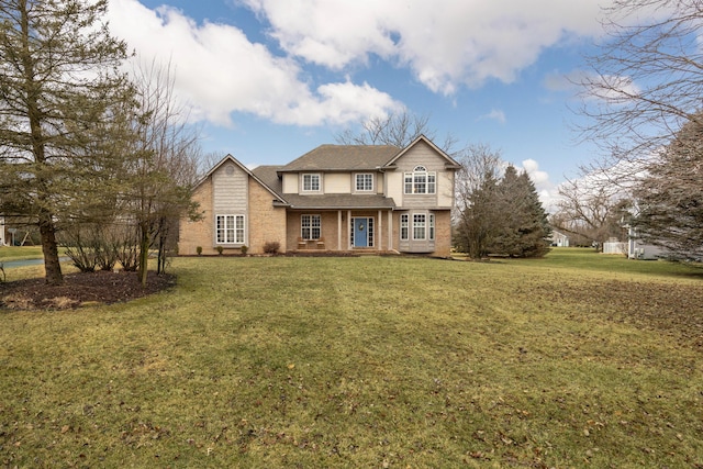 traditional-style home featuring brick siding and a front lawn