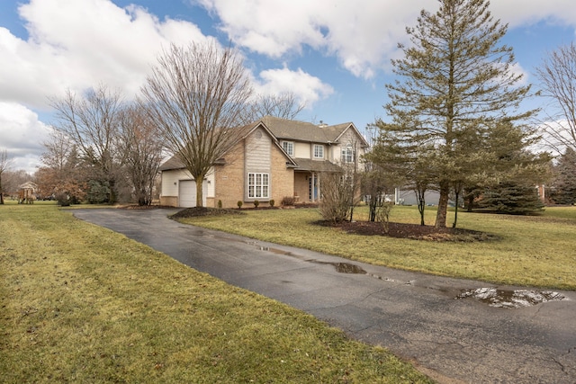 view of front of property featuring a garage, brick siding, aphalt driveway, and a front yard